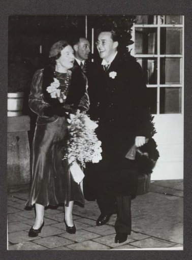 Queen Juliana and Prince Bernhard in winter clothing at an official occasion