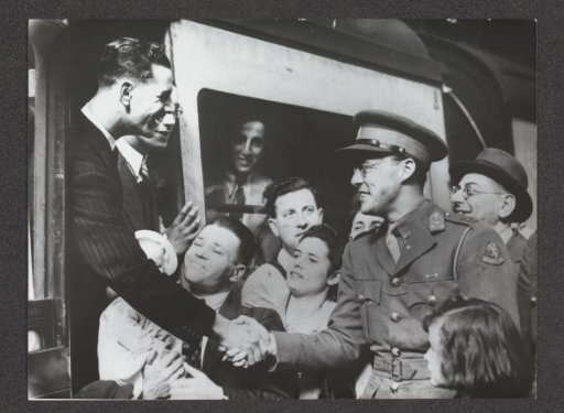 Prince Bernhard in uniform shaking hands with a man departing by train