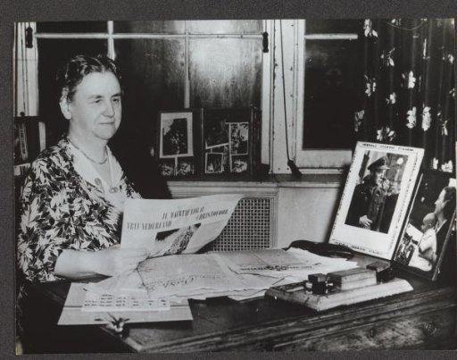 Queen Wilhelmina reading a Dutch resistance newspaper in her study in London