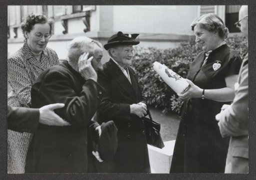 An Old Lady and a Gentleman Present a Vase to Queen Juliana