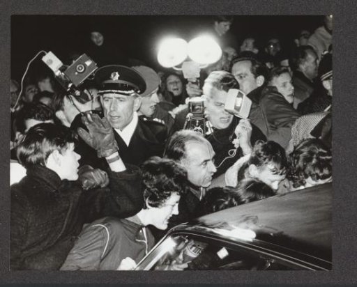 Crowd surrounding the car with Princess Irene and Prince Carlos