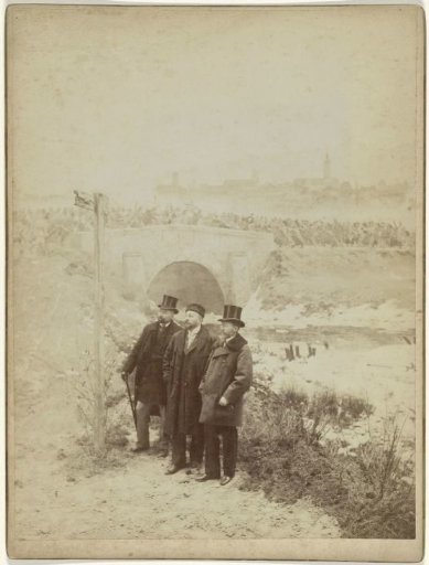 Studio portrait of Adam Styka and two men