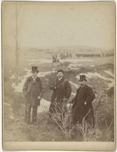 Studio portrait of Adam Styka and two men