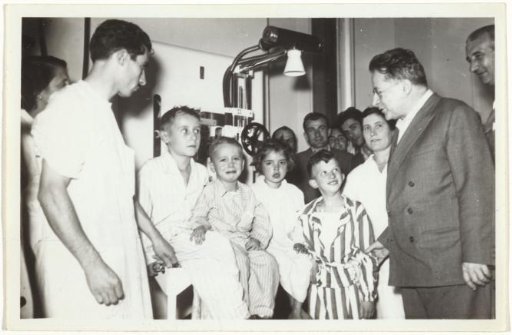 Palmiro Togliatti talks with patients and doctors after donating medical equipment to a hospital in Rome