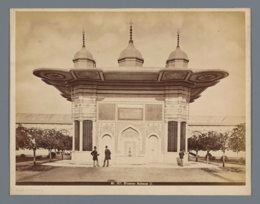 Three men in front of the fountain of Ahmet III in Istanbul, Turkey