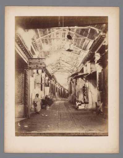 Bazaar in the Medina of Tunis, on the left the warehouse of Piperno Père & fils