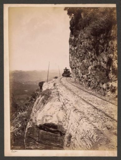 Train passes by the Sensation Rock between Kandy and Colombo, Sri Lanka
