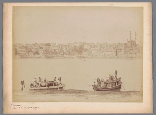 View of the ghats on the banks of the Ganga with ships on the foreground in Varanasi, Uttar Pradesh, India