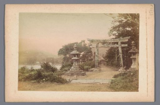 Village on a coast in Japan, in the foreground a torii