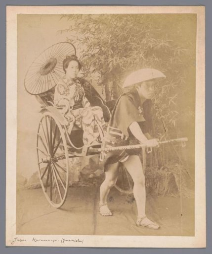 Staged double portrait of an unknown woman with parasol in a rickshaw pulled by a man
