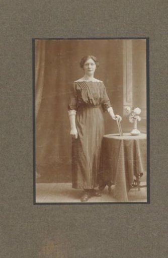 Studio portrait of a woman with a book at a table