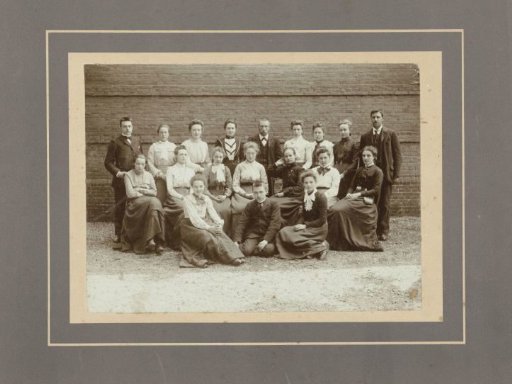 Group portrait of young men and women in front of a wall