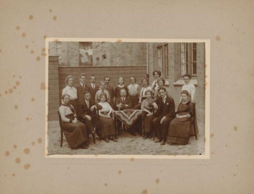 School photograph of a class with teachers around a table in a garden