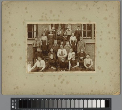 School photograph of a class around the teacher