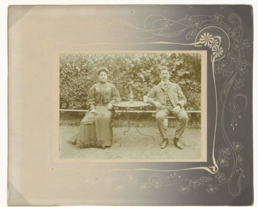 Portrait of a seated married couple in a garden