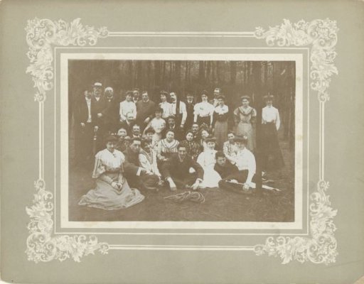 Group portrait of unknown young men and women in a forest