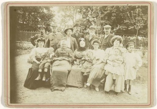 Family portrait of unknown members of three generations in a garden
