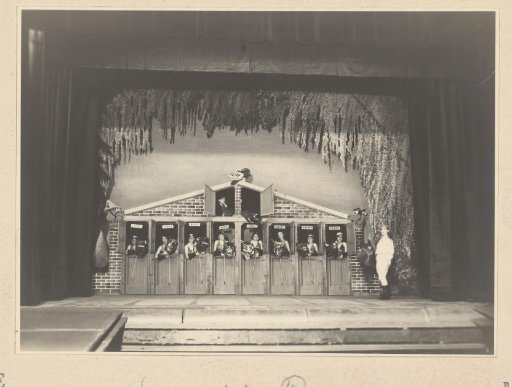 Theatre photo of actors in decor with a horse stable