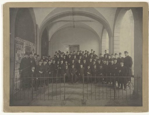 Group portrait of men with bowler hats in the foyer of a theatre