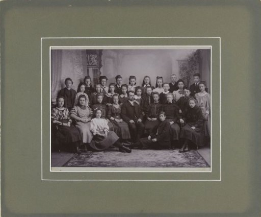 Group portrait of an unknown school class and their teacher