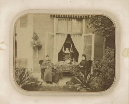 Portrait of an elderly couple at a table on a veranda