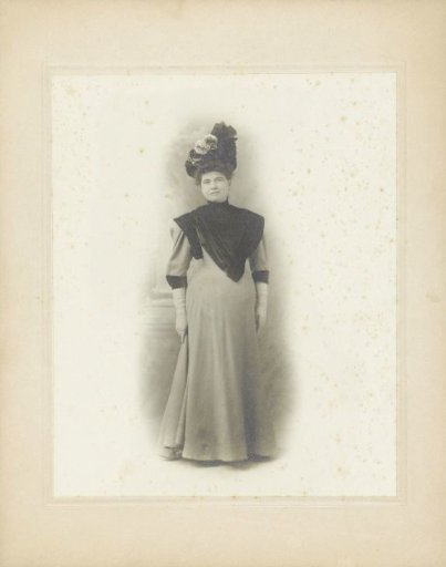 Portrait of an unknown standing woman in a kimono with fur and hat