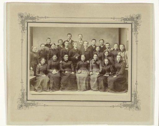 Studio portrait of a family, taken in front of a backdrop