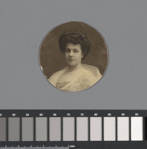 Portrait of a woman in walking costume by a bench