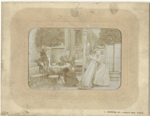 Group portrait of an unknown man, woman and harp-playing girl with dog on a terrace