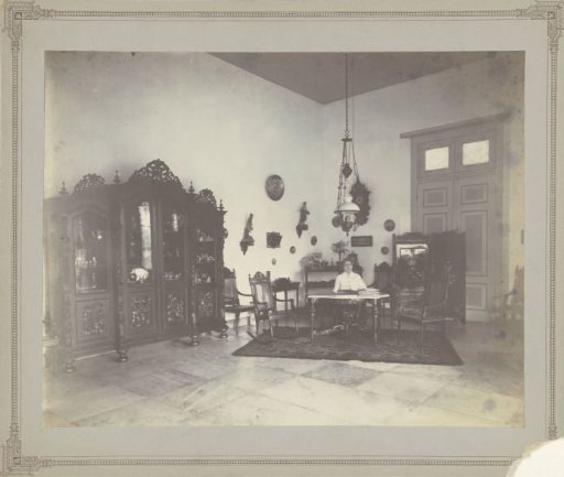Living room with colonial interior featuring an unknown woman, Dutch East Indies