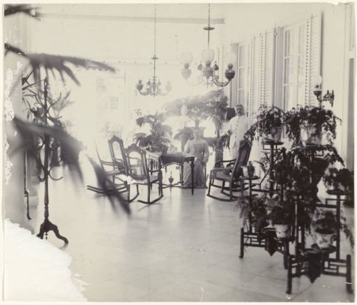 Portrait of an unknown couple on a veranda in Dutch East Indies