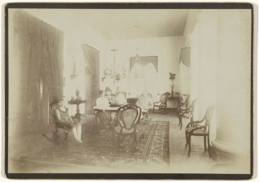 Group portrait of an unknown family in an interior, probably in Dutch East Indies