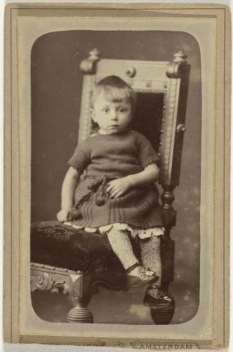 Studio portrait with a small child on a chair
