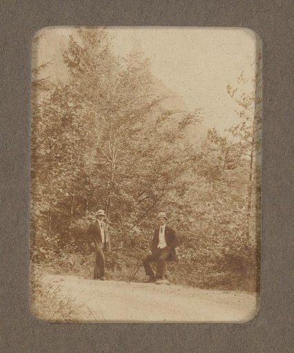 Two Young Men, Identified as Miel and Frits, Along a Road in a Wooded Area