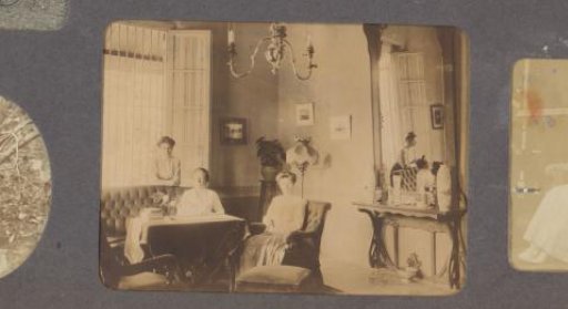 View of a domestic interior with three women, possibly in Indonesia