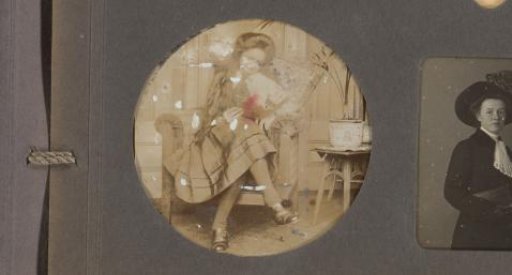 Portrait of Wiesje Merkus with a book in an armchair