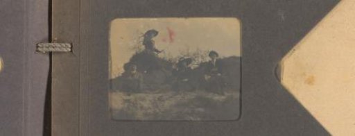Three women and a man on a sandy slope