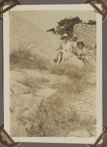 Women sitting at a monastery entrance, probably in southern France