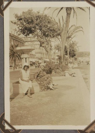 Three women sitting on the Promenade des Anglais in Nice