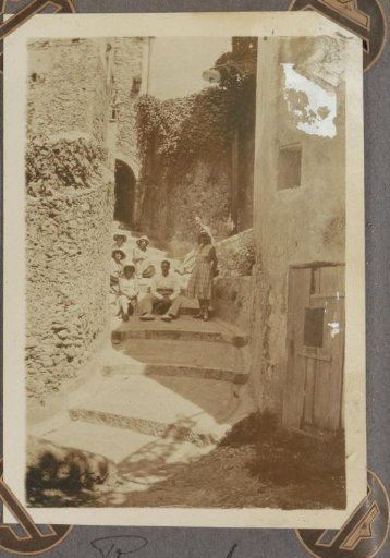 Group sitting on the steps of a street in Roquebrune-Cap-Martin