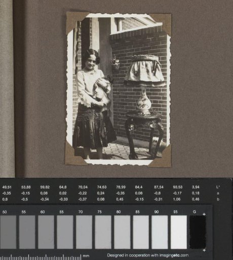 Henriëtte Wassink with a dog on a balcony or in a garden