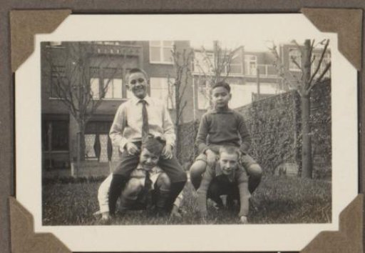 Dicky Baud and three other boys playing in a garden