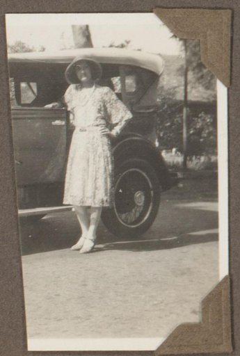 Woman standing by a car