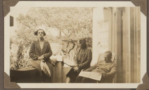 Two women and a man on a balcony