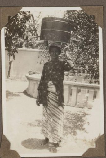 Portrait of a woman with a cask on her head