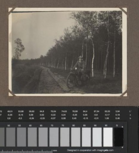 Johannes van Zijll de Jong on a motorcycle by a forest path