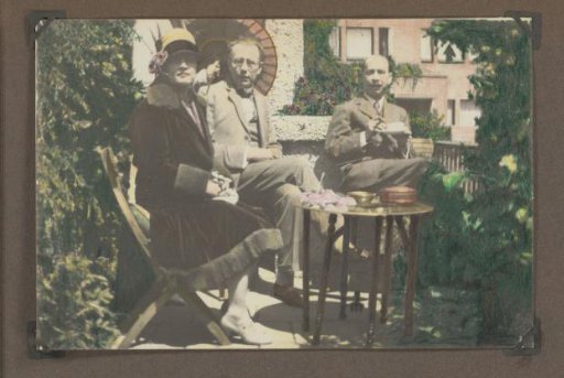 Henriëtte Wassink, an unknown man, and Meinard Dorus Mijer seated in a garden or on a balcony