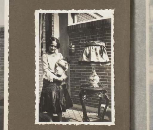 Henriëtte Wassink with a Dog and a Table Lamp in a Garden
