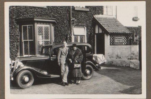 Young man and a woman by a car, London