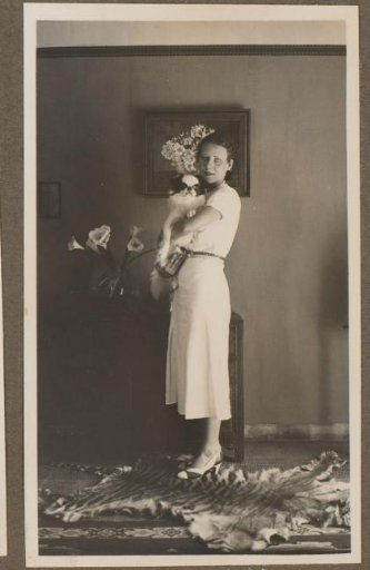 Portrait of a woman with a dog in a living room